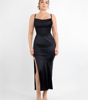 Model wearing black corset bodysuit with pleated long skirt, showing adjustable straps and defined waistline