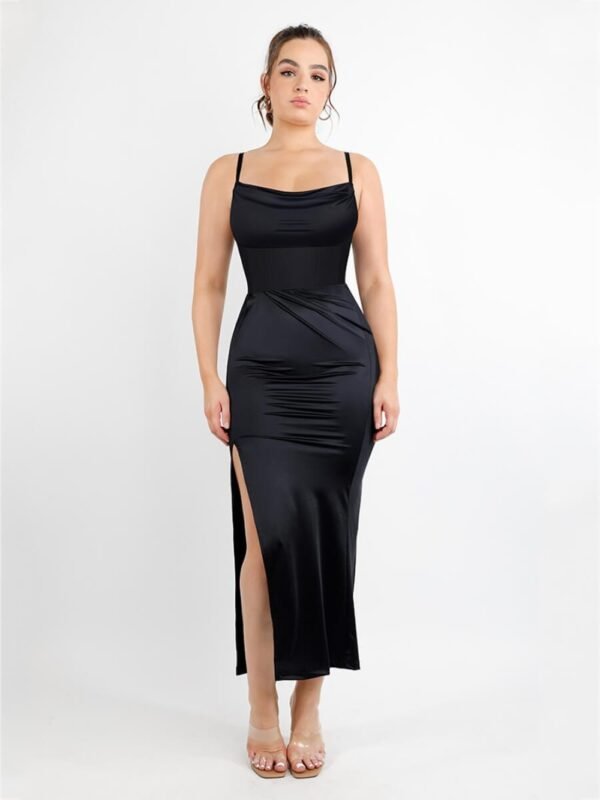 Model wearing black corset bodysuit with pleated long skirt, showing adjustable straps and defined waistline