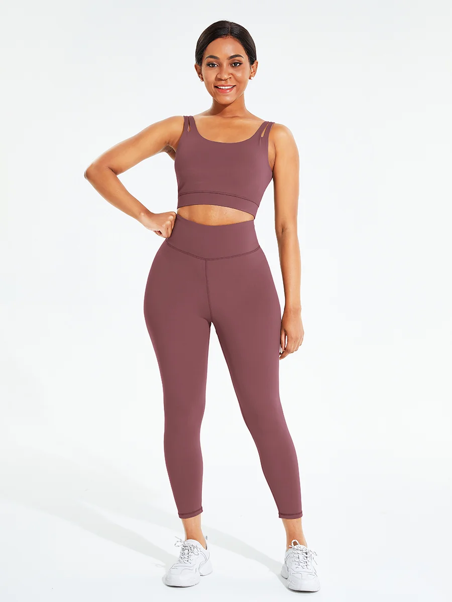Two-piece hollow out athletic set with sports bra and high-waisted full-length leggings featuring hidden pocket, ideal for workouts or casual wear.